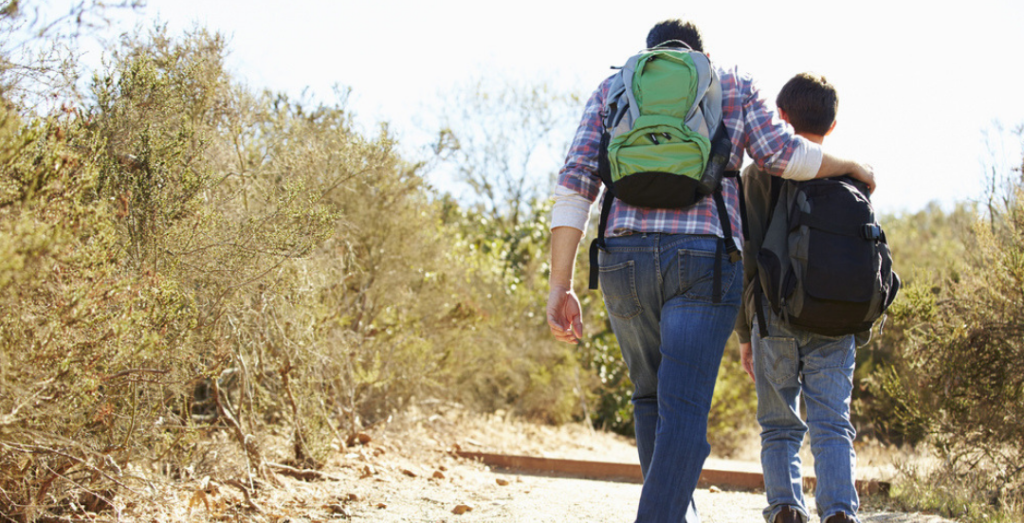 Man holding a kid while walking