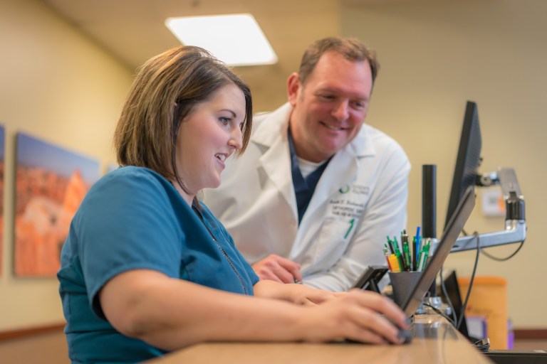 Doctor & nurse smiling