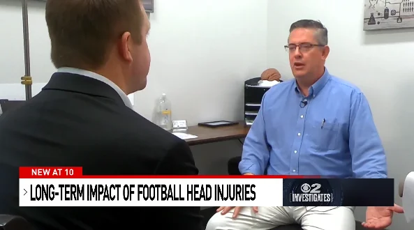 Image of Dr. Ben Christiansen in a news segment about head injuries in football