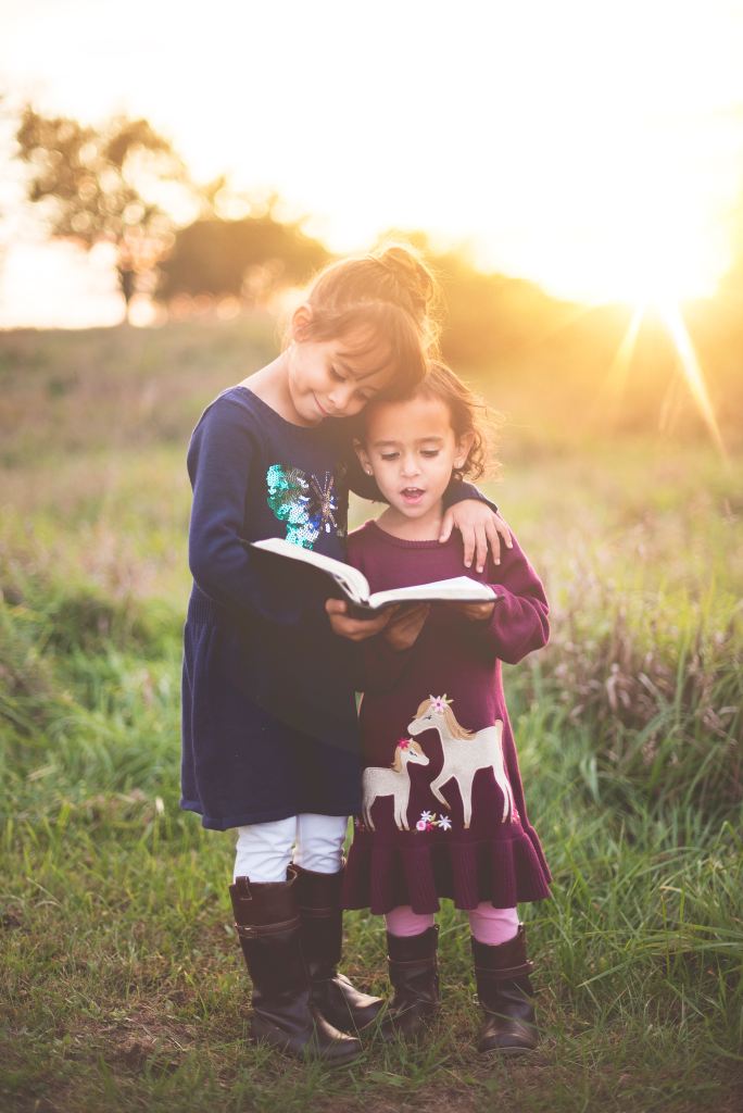 two kids reading book